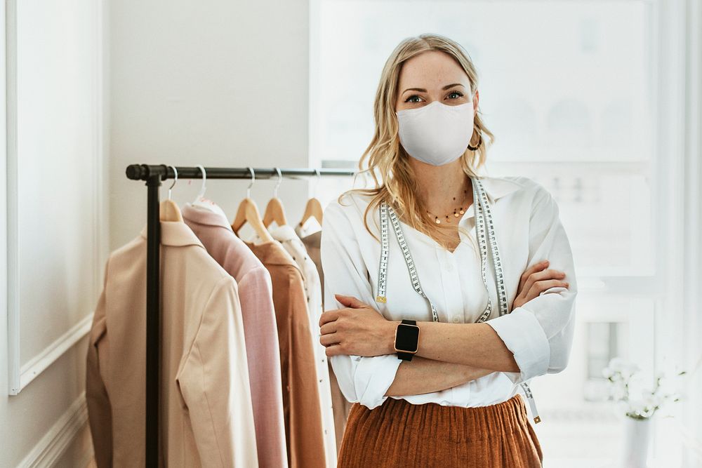 Designer in new normal boutique wearing mask, covid 19