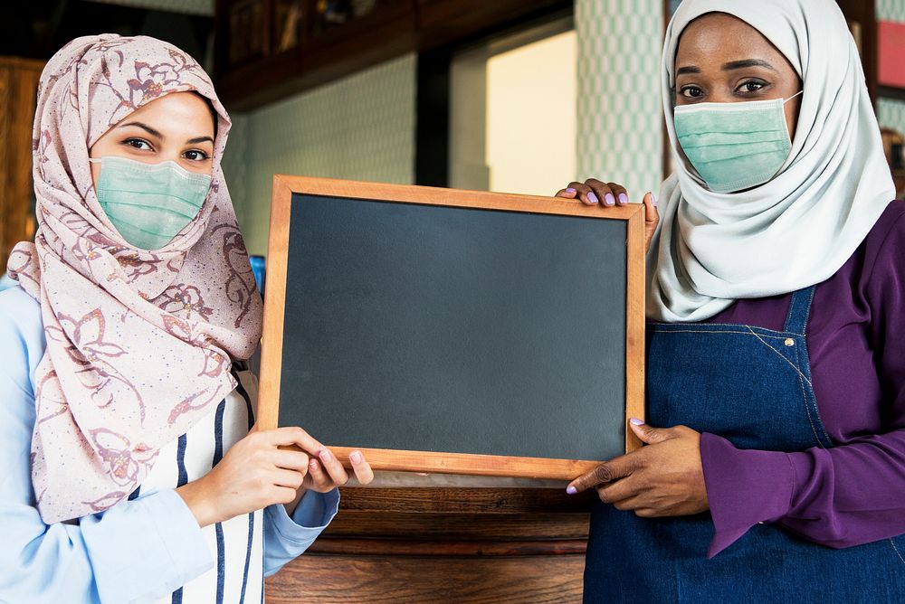Muslim business owners in face mask reopening shop in the new normal, covid 19