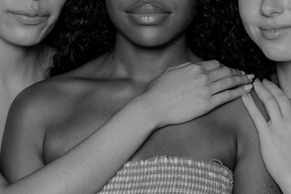 Black and white women holding each other closeup