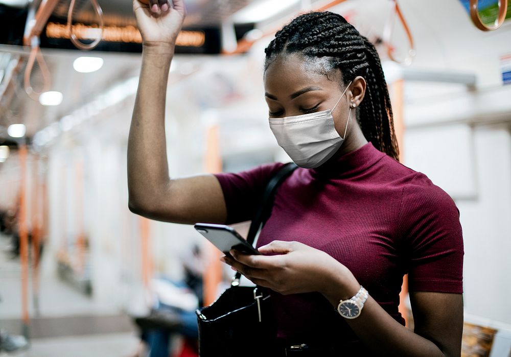 African American woman wearing mask on the bus while using public transportation in the new normal