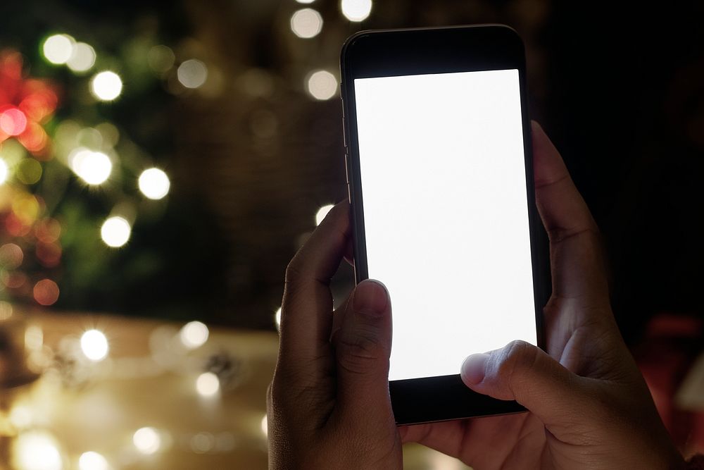Smartphone screen mockup psd at a Christmas party