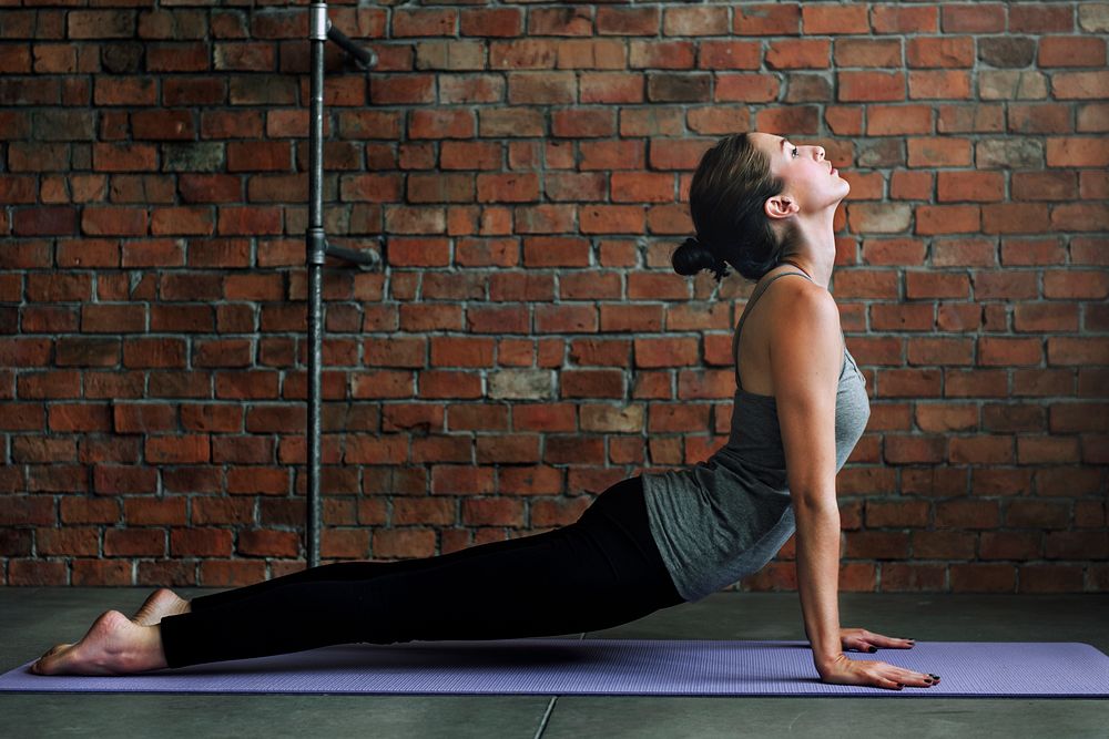 Woman stretching on a yoga mat 