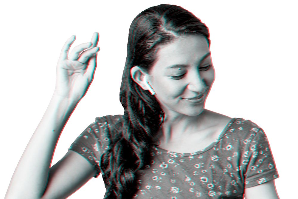 Woman listening to music through wireless earphones in double color exposure effect