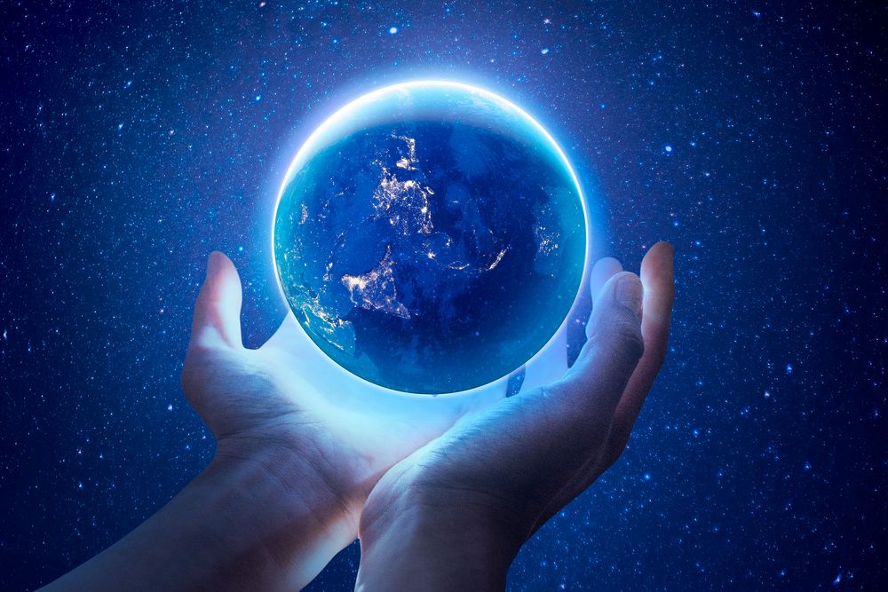 Glowing globe background, hand holding, remixed media design