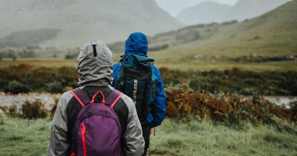 Couple trekking through the rain in the Highlands