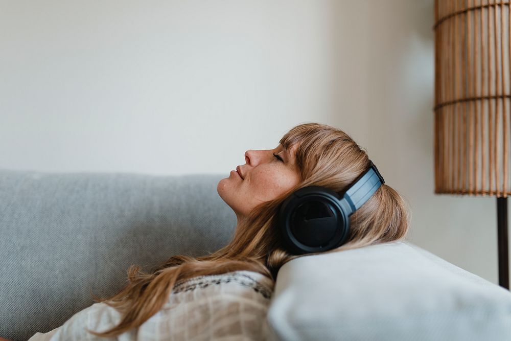 Woman listening to music at home during coronavirus pandemic 