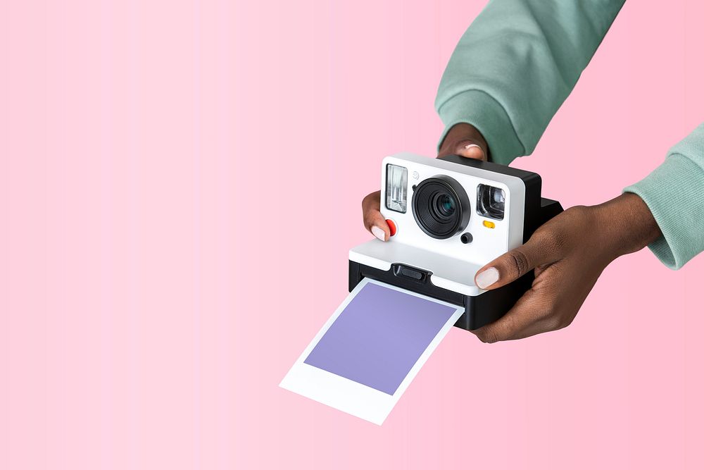 Hands holding an instant camera photo 