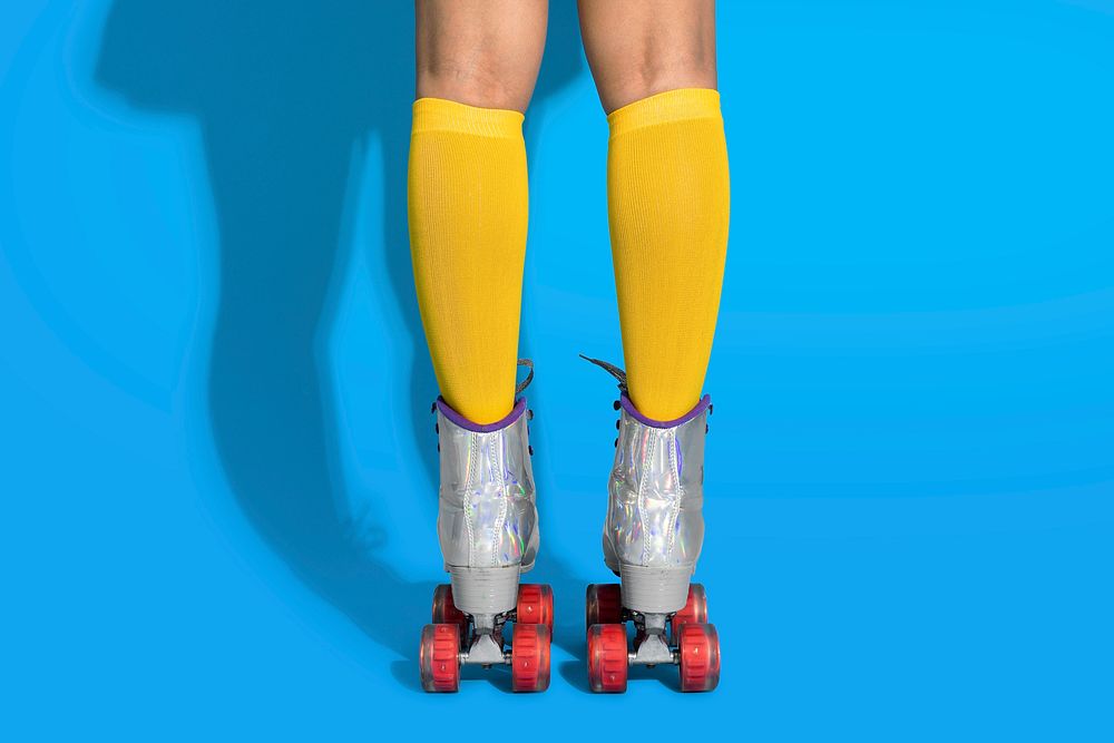 Legs in a roller skates shoes with blue background