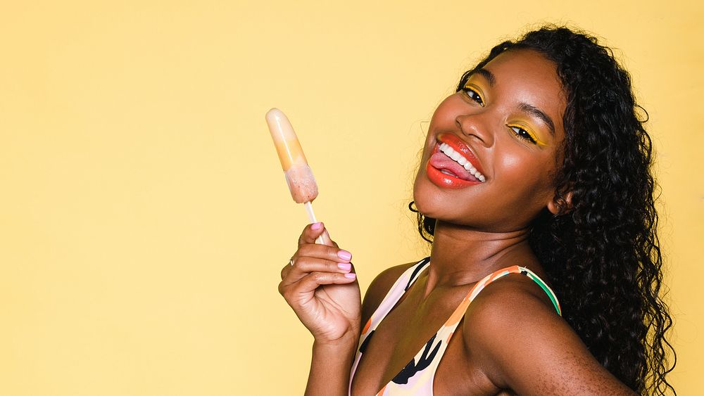 Happy black woman having an ice pop