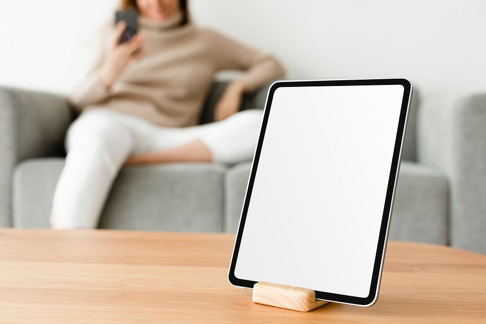 Digital tablet with blank screen on wooden table