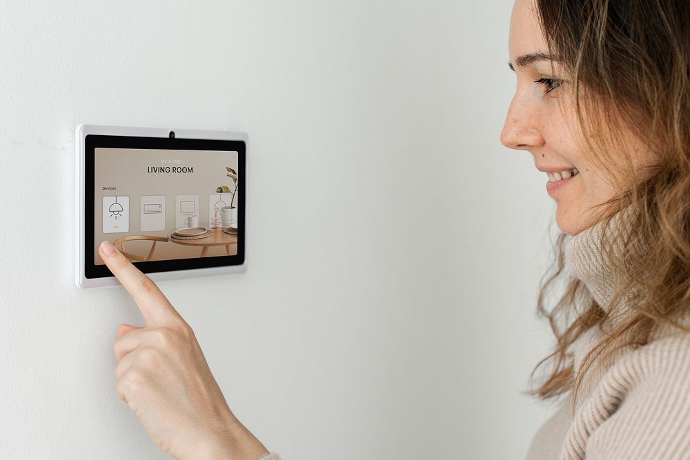 Woman pressing on smart home automation panel monitor