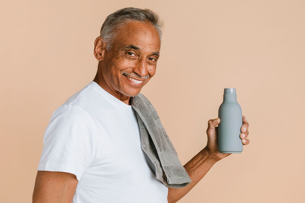 Sporty mixed Indian man holding a water bottle