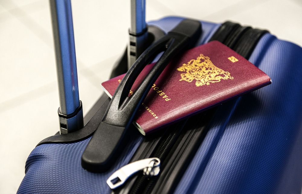 Free passport on suitcase photo, public domain CC0 image.