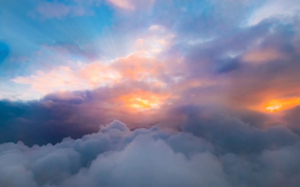 Sunrise behind clouds, free public domain CC0 image.