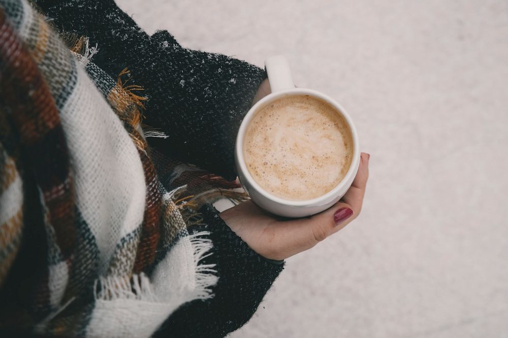 Person holding a cup of hot chocolate in winter. Original public domain image from Wikimedia Commons