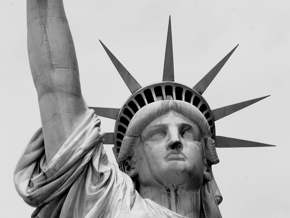 Black and white closeup photo of the Statue of Liberty's face. Original public domain image from Wikimedia Commons