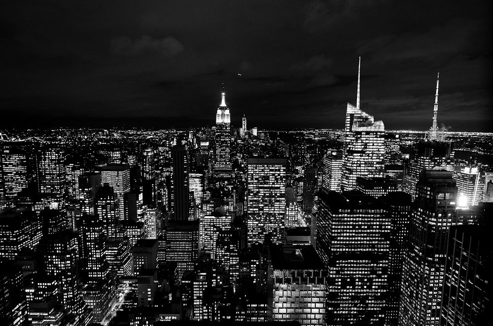 Black and white photo of the New York City skyscraper lights at night. Original public domain image from Wikimedia Commons