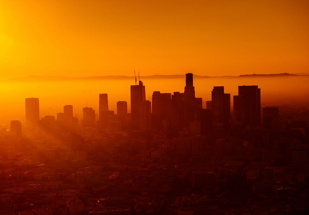 Warm orange sunset behind the skyline of Los Angeles. Original public domain image from Wikimedia Commons