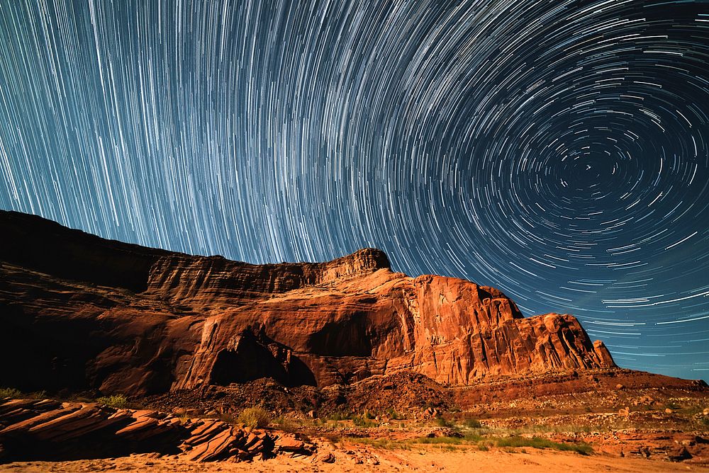 A blurry background image that perfectly captures swirling stars in a night sky over Lake Powell. Original public domain…