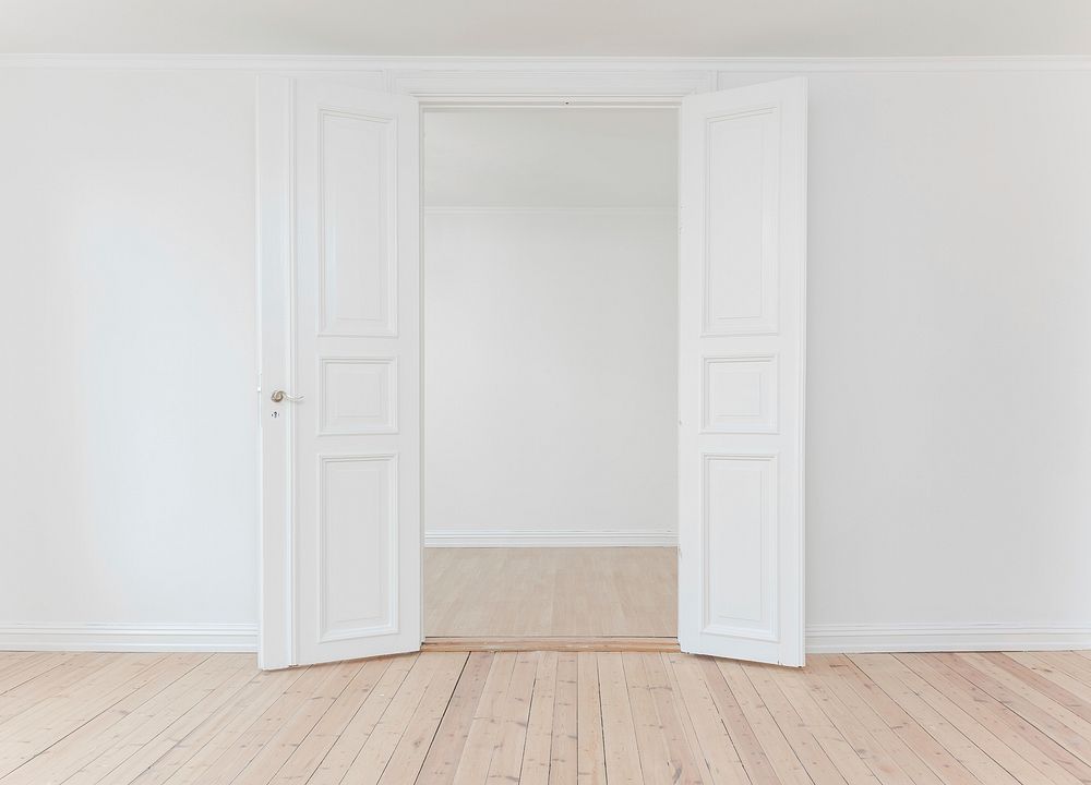 White double door in an empty room painted white. Original public domain image from Wikimedia Commons