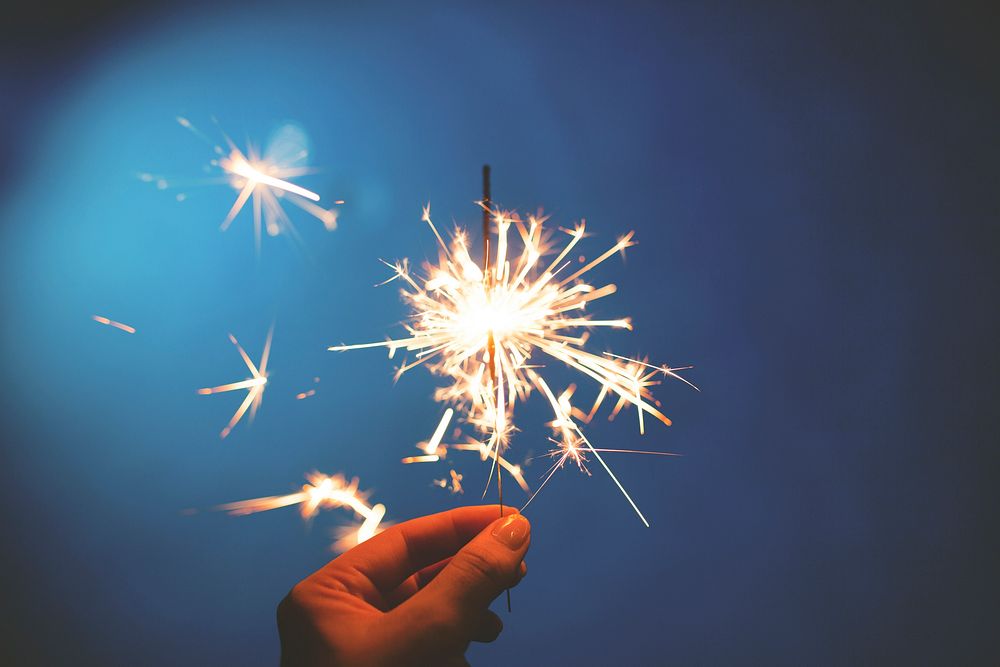 Hand holding a sparkler. Original public domain image from Wikimedia Commons