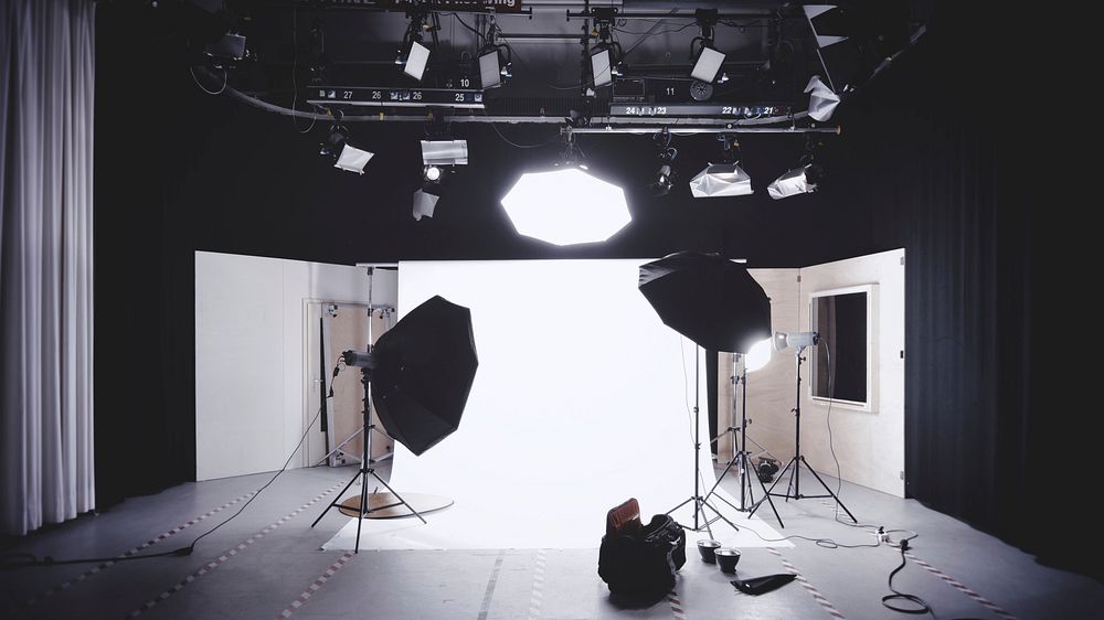 A photographic studio with a backdrop, lights, and softboxes. Original public domain image from Wikimedia Commons