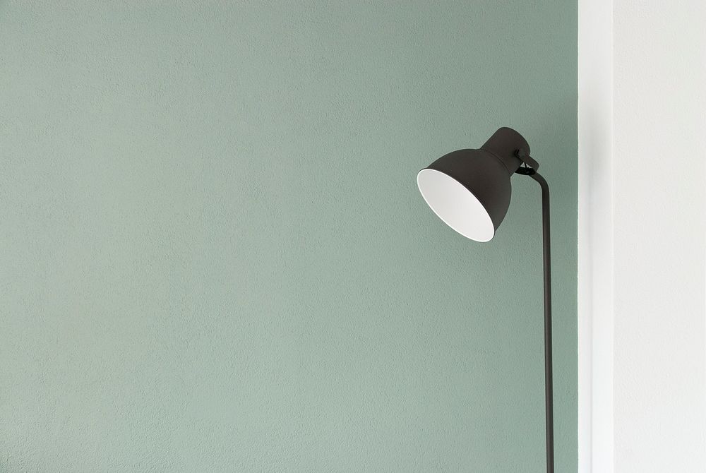 A floor lamp against a pastel green wall. Original public domain image from Wikimedia Commons