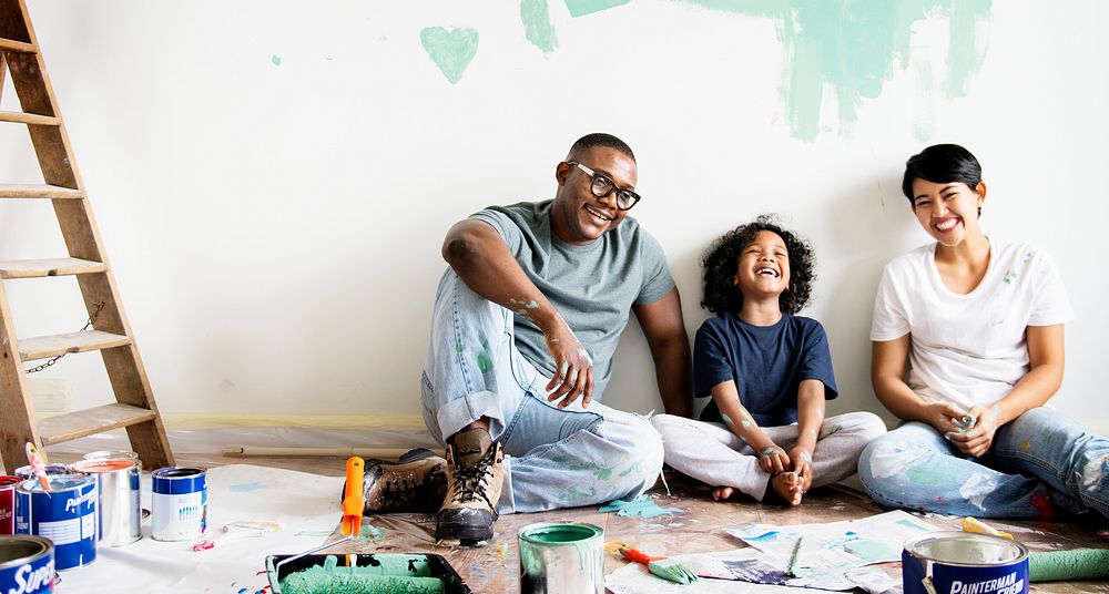 Black family painting house wall for interior design