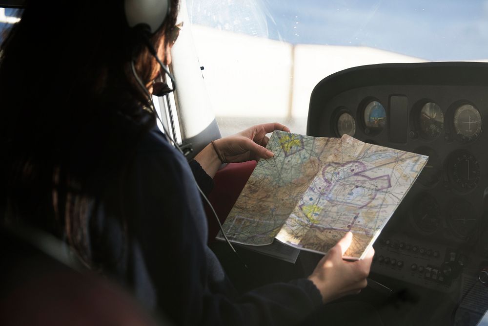 Aviator looking at a map before departure