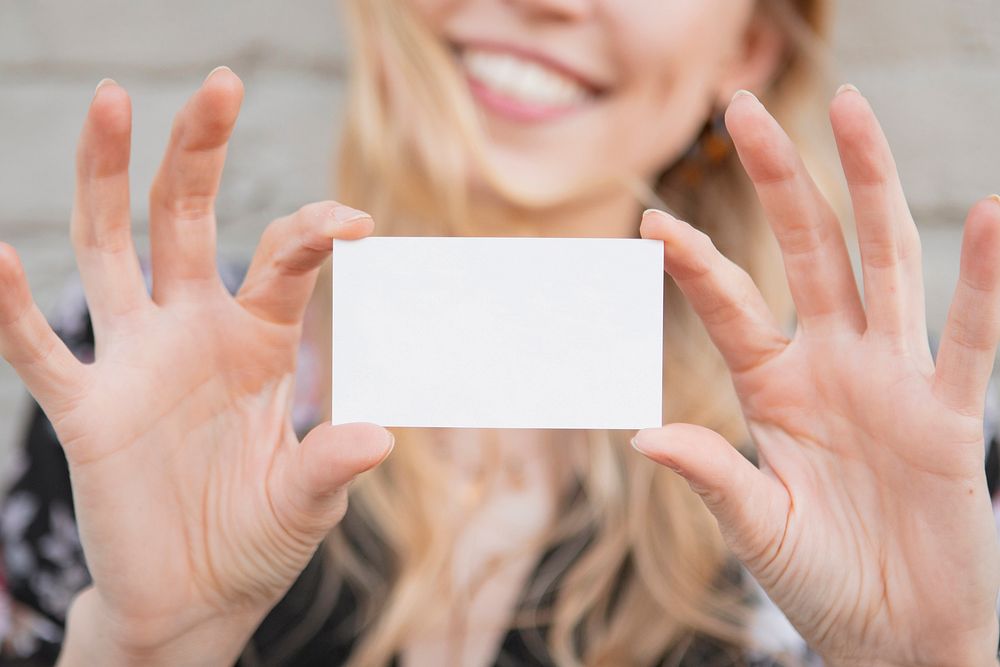 Cheerful white woman showing an empty card