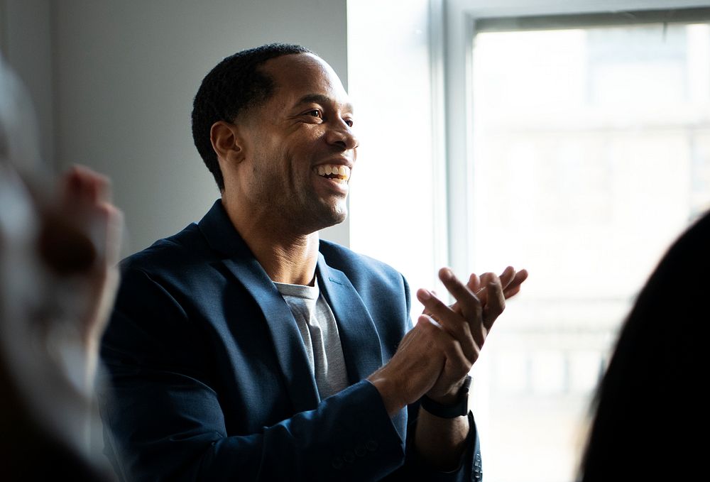African American man clapping in a seminar