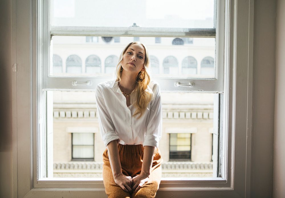 Woman sitting on a window sill