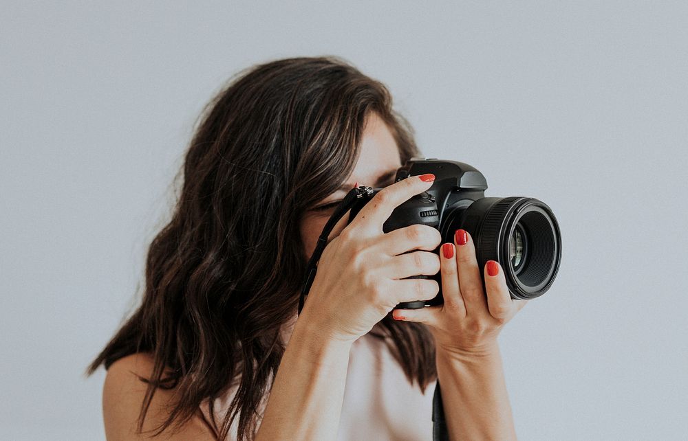 Female photographer holding digital camera