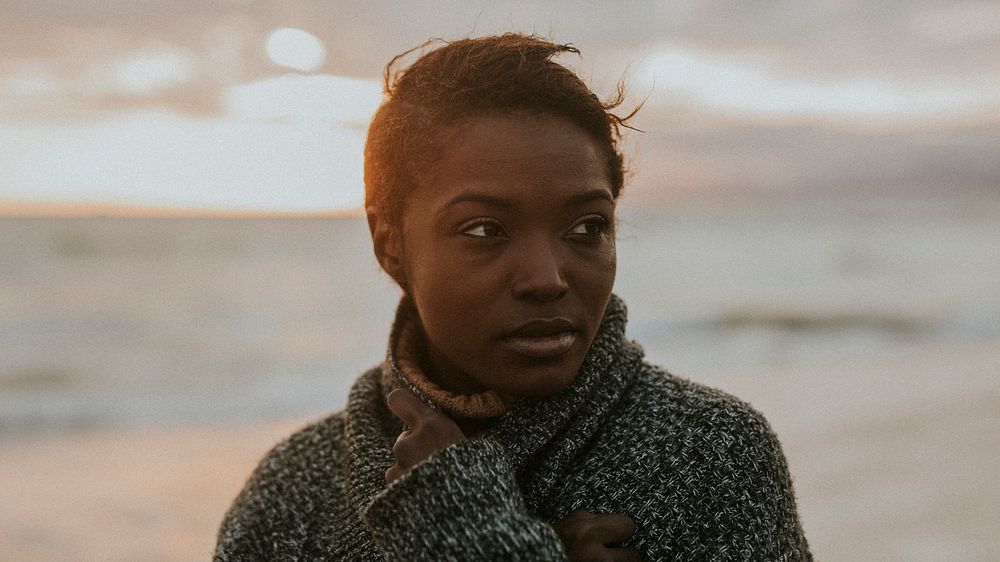 Black woman at the beach during sunset