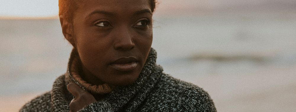 Black woman at the beach during sunset social banner