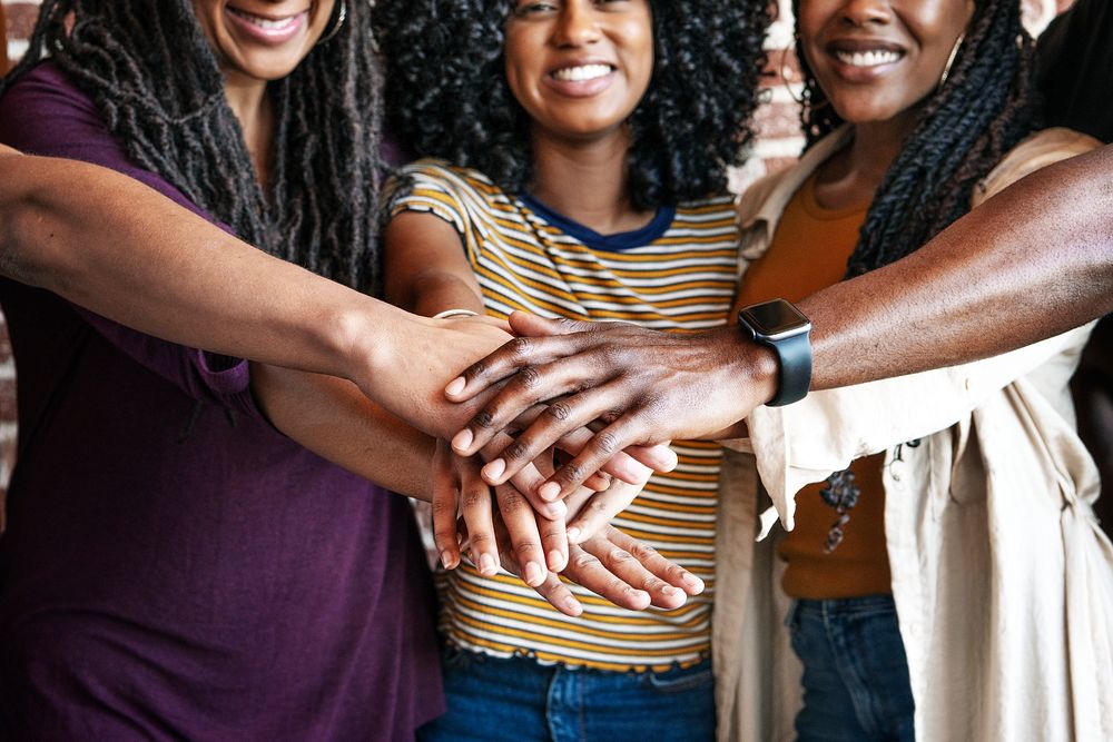Women stacking hands in the middle