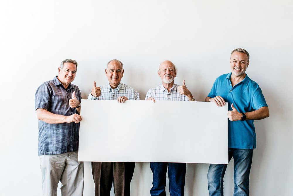 Elderly men holding a blank poster