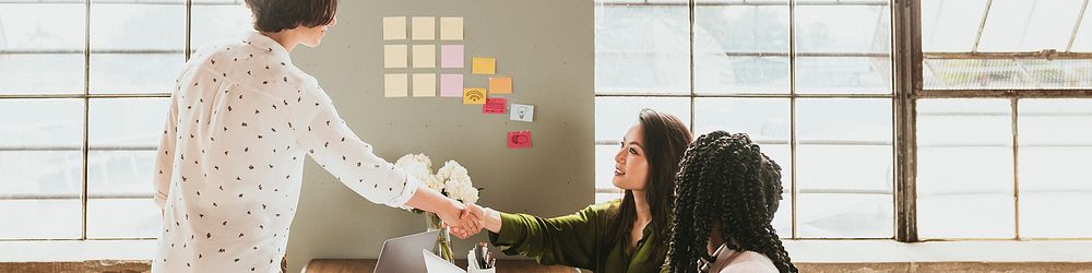 Happy businesswomen doing a handshake social template