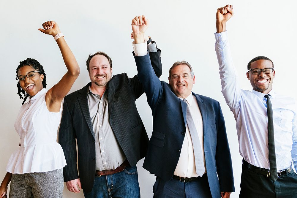 Diverse business team raising hands up in the air