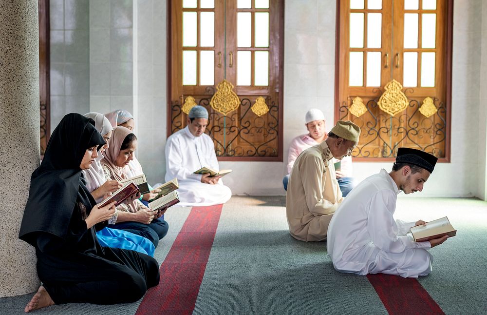 Muslims reading from the Quran