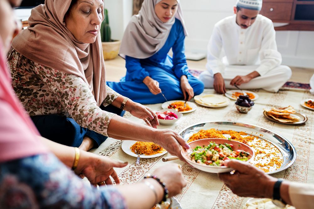 Muslim family having dinner on the floor