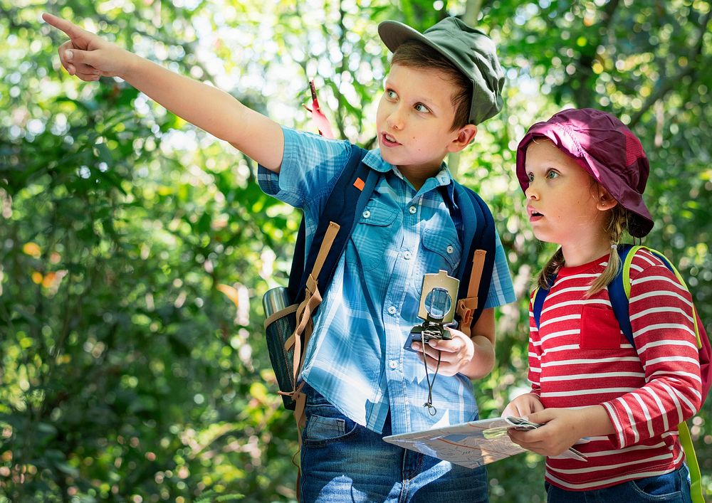 Two cute kids trekking in the forest