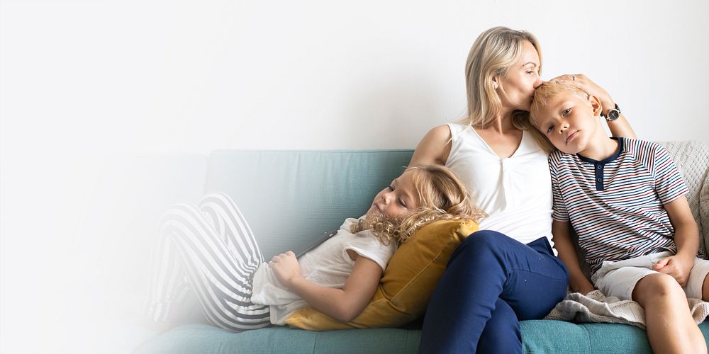 Blonde mom kissing her son&rsquo;s head and relaxing with daughter on the couch design space 