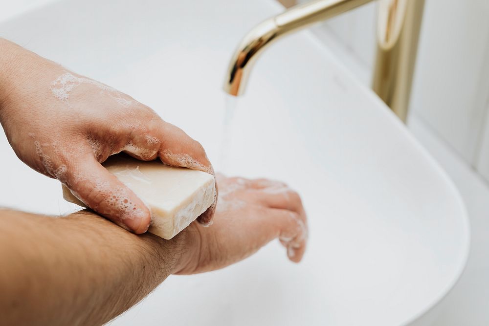Man using a bar soap to wash his hands