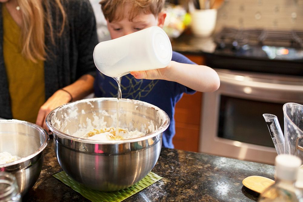 Kid learning how to bake with mom education photo
