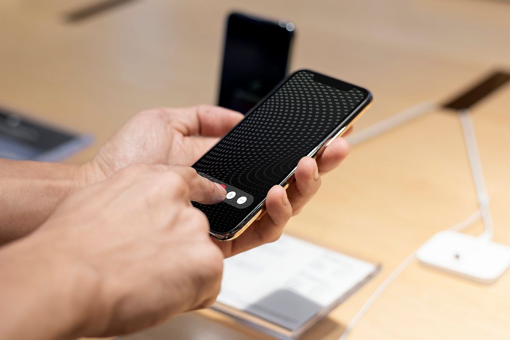 Man trying the newest smartphone at a tech shop