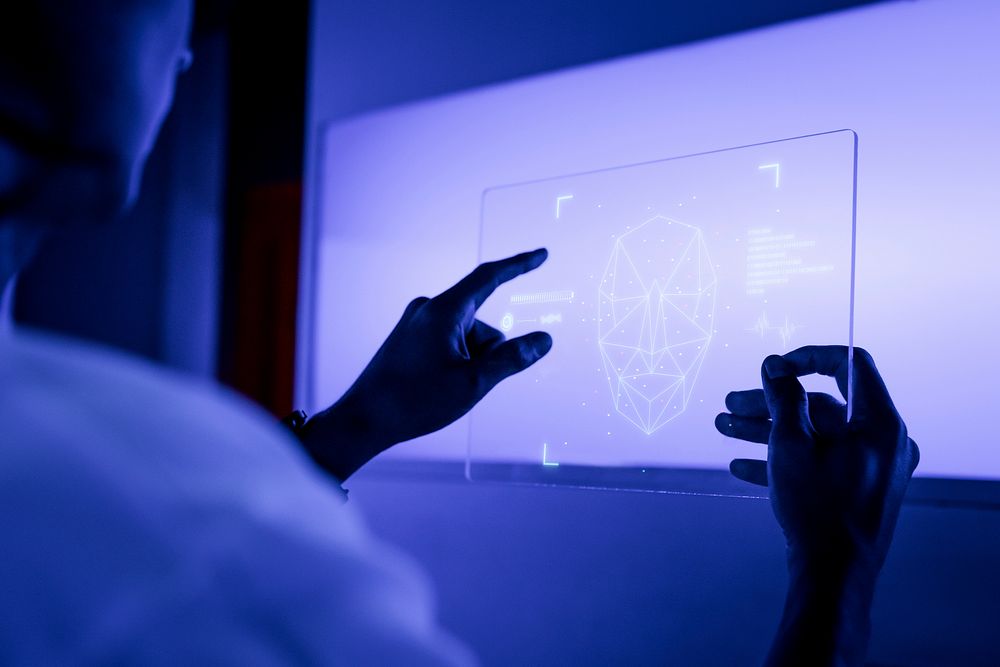Designer using a transparent digital tablet screen futuristic technology