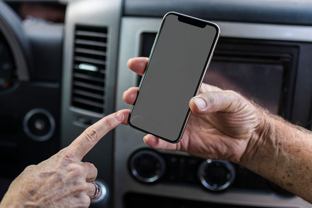 Grandpa showing his smartphone to grandma