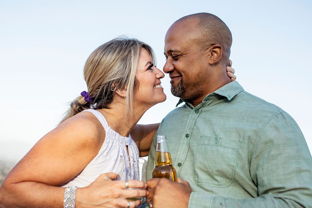 Husband and wife having a drink on the balcony