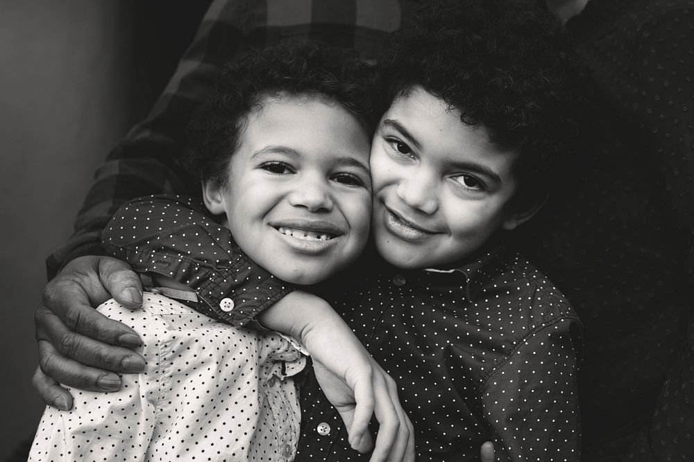 Two cute mixed race brothers hugging